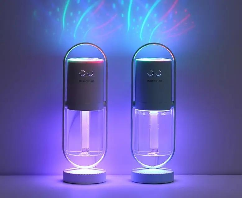 Pair of USB ultrasonic mini air humidifiers with projection night lights for home or office, colorful ambient glow.