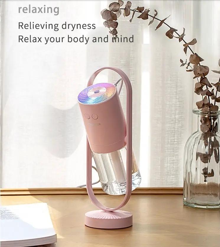 Pink USB ultrasonic mini air humidifier with projection night lights for home office on desk.