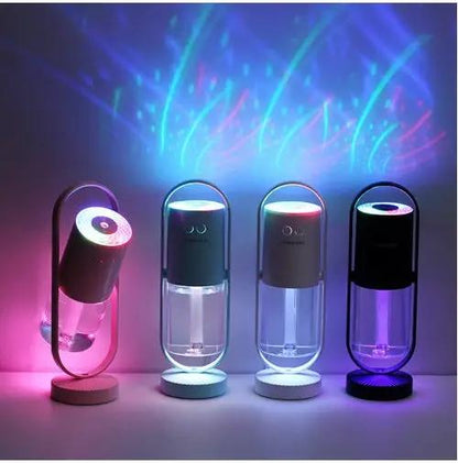 Four USB ultrasonic mini air humidifiers with projection night lights in pink, blue, teal, and purple.