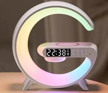 G-shaped LED lamp with Bluetooth speaker, wireless charger, app control; rainbow-lit ring and clock.