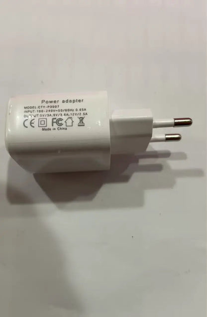 White wall power adapter with European two-pin plug and printed electrical specs label.